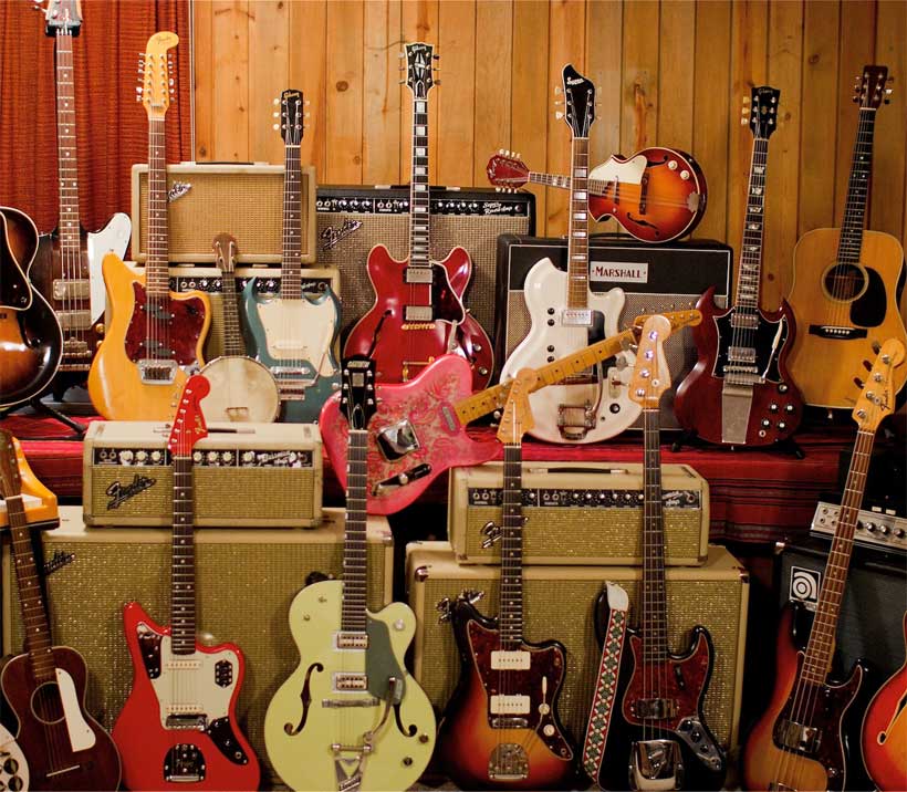Gitar fiyatları ve farklı tipteki onlarca gitarın bulunduğu bir stand